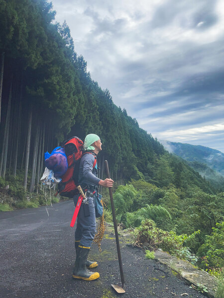 奥多摩の山道に立つプロジェクト代表 松村和大